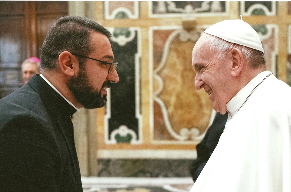 The Rev. Karam Qasha, left, meets Pope Francis. Photo via Facebook